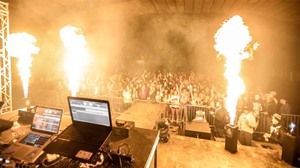 View from onstage at a DJ performance with pyrotechnics